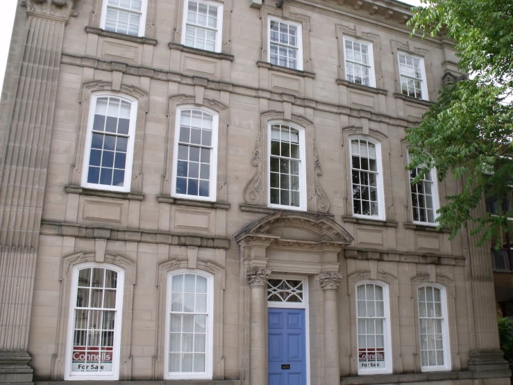 a two story stone building with several windows