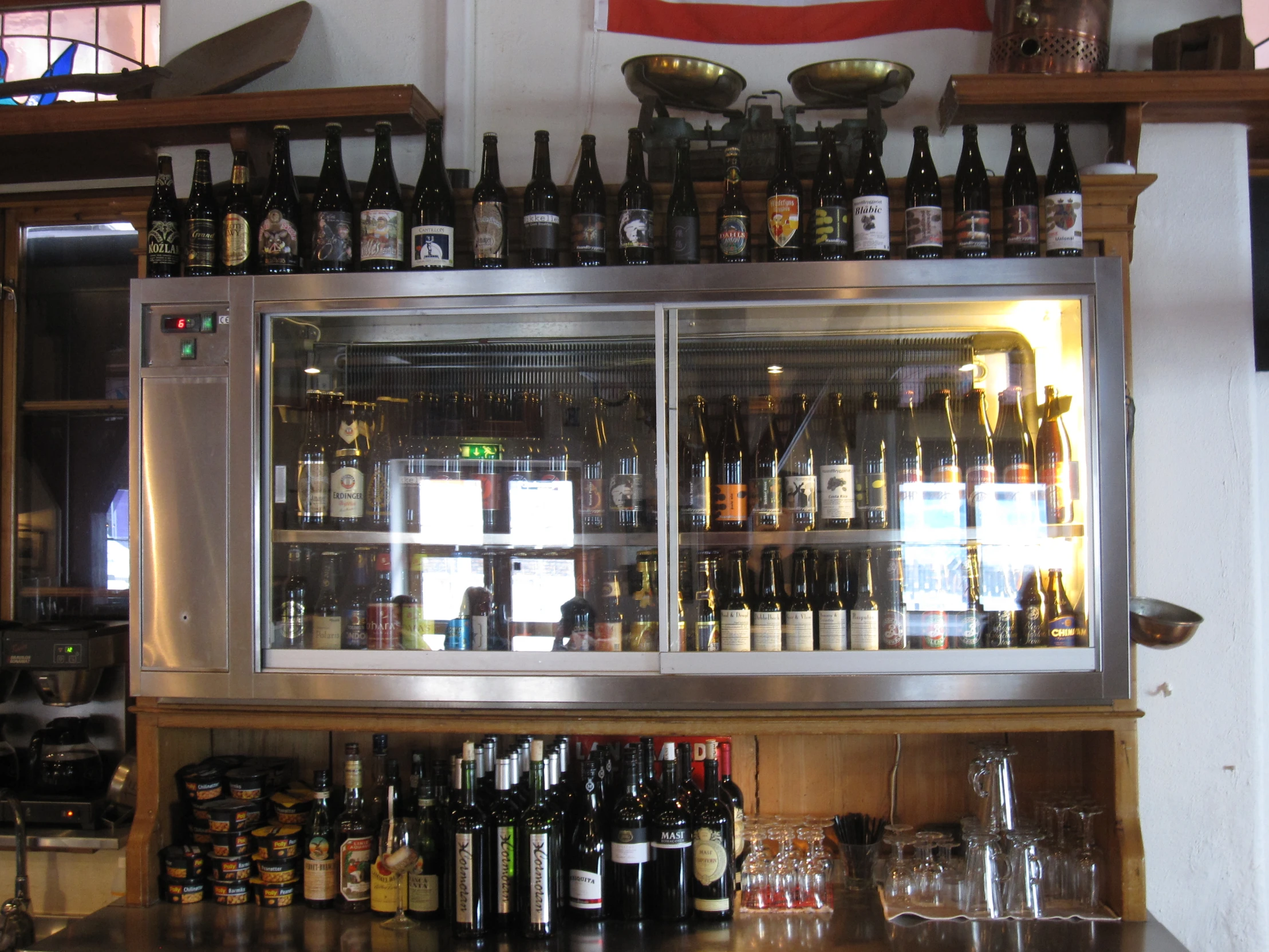 bottles and wine glasses are displayed in front of a bar