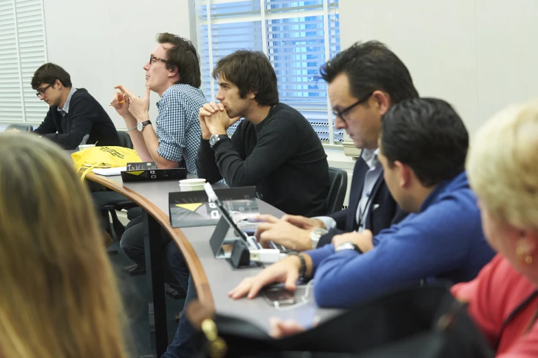 group of young people attending to a meeting