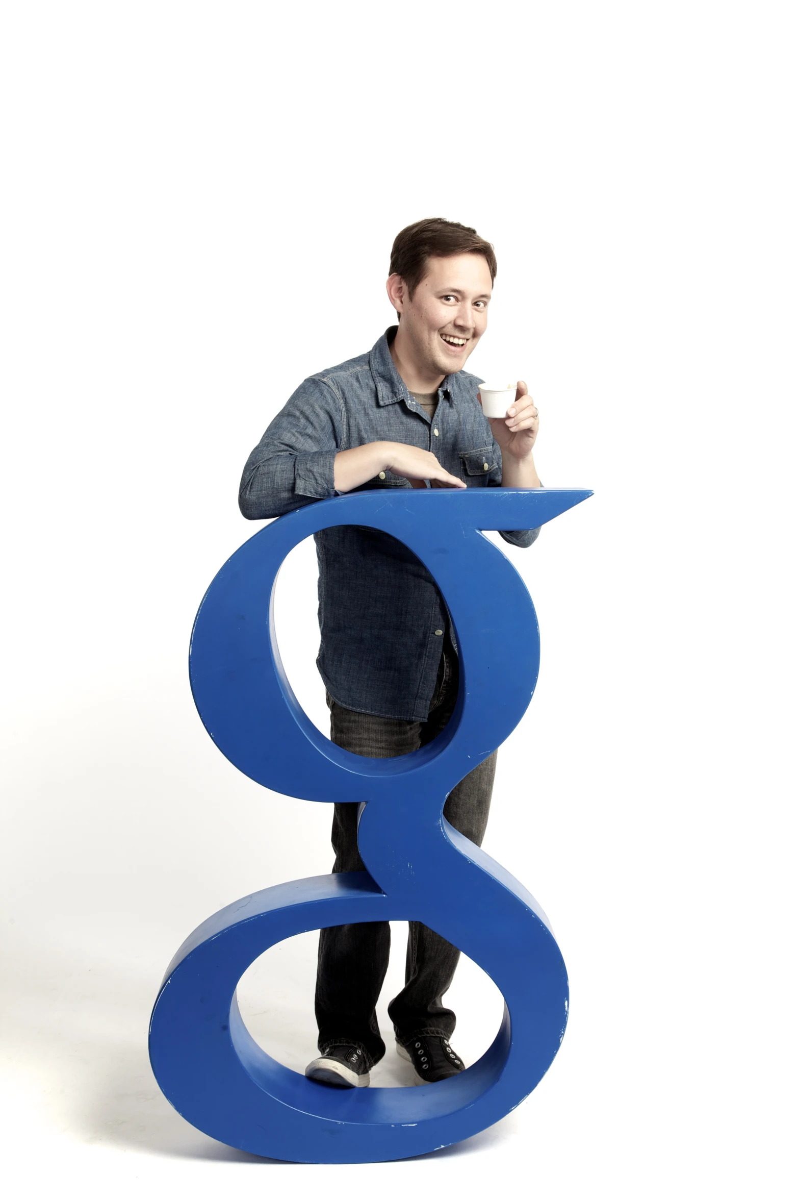 a man standing next to a sign in blue