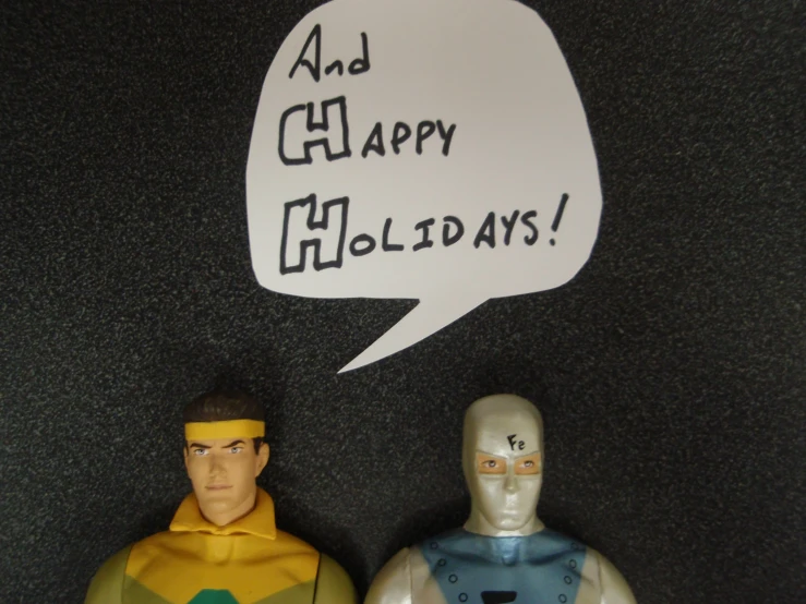 two plastic toy figurines with an empty speech bubble above them