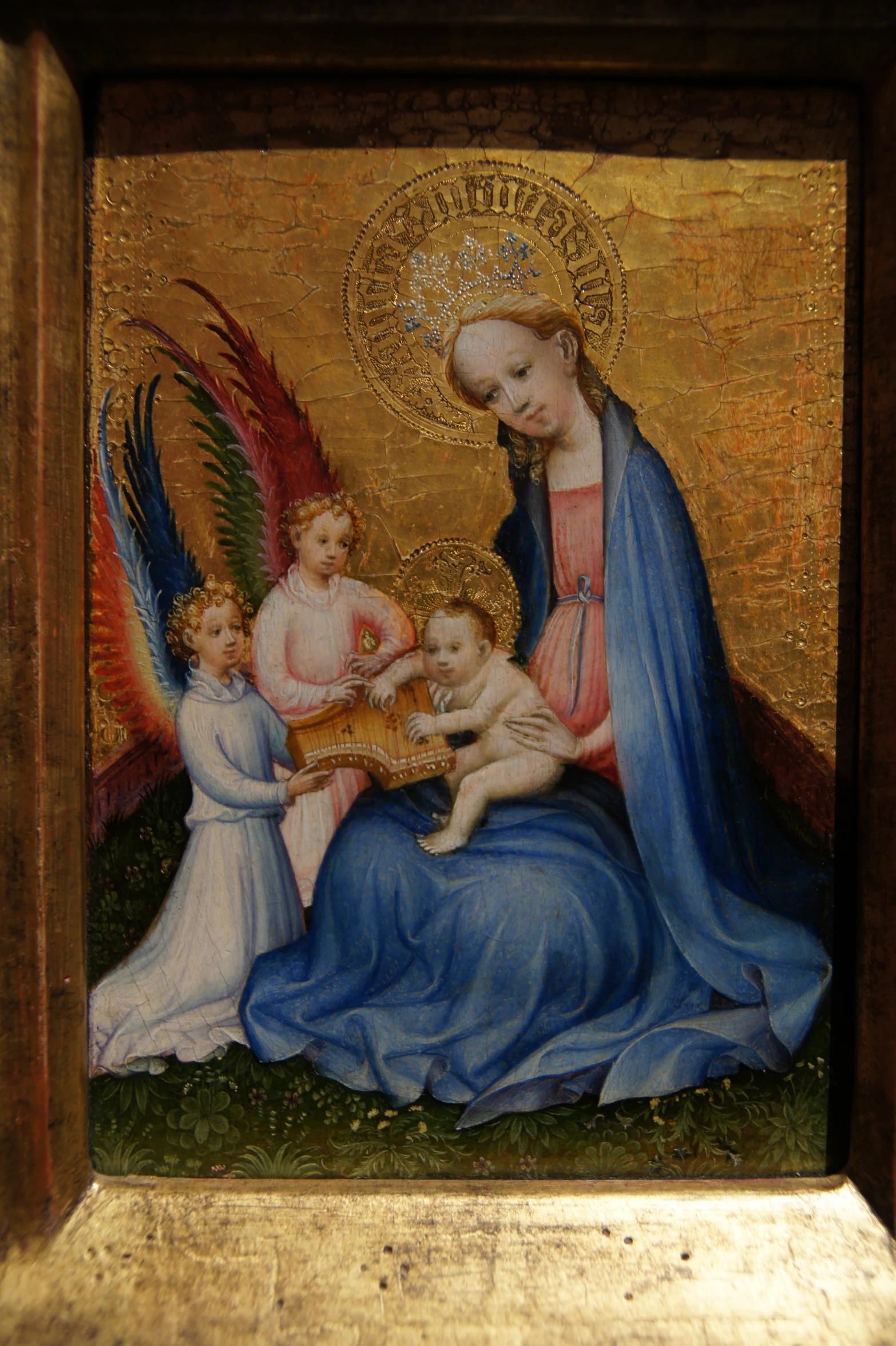 a painting showing the virgin and child surrounded by angels