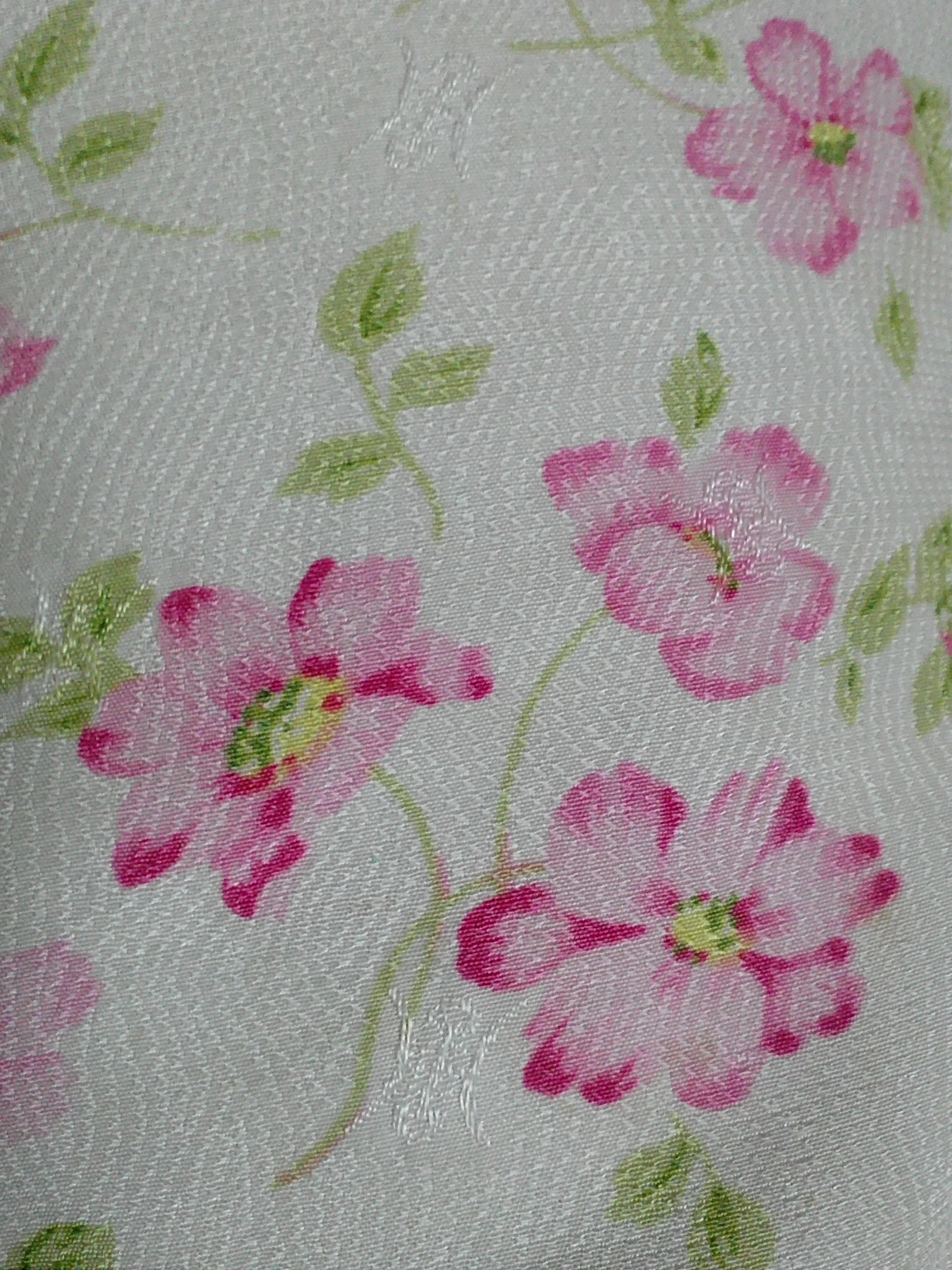 a flower - printed tablecloth shows the pink flowers