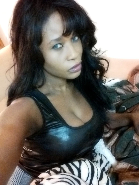 a beautiful young black woman posing in a black leather top