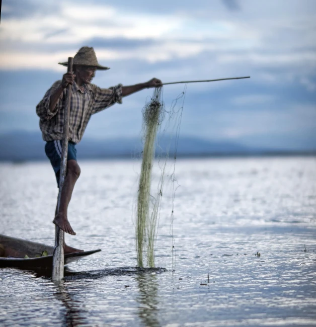 a man standing on top of a boat in the water