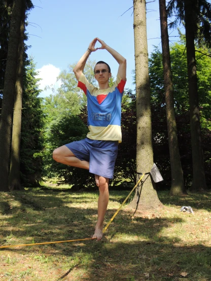 a person that is doing yoga by some trees
