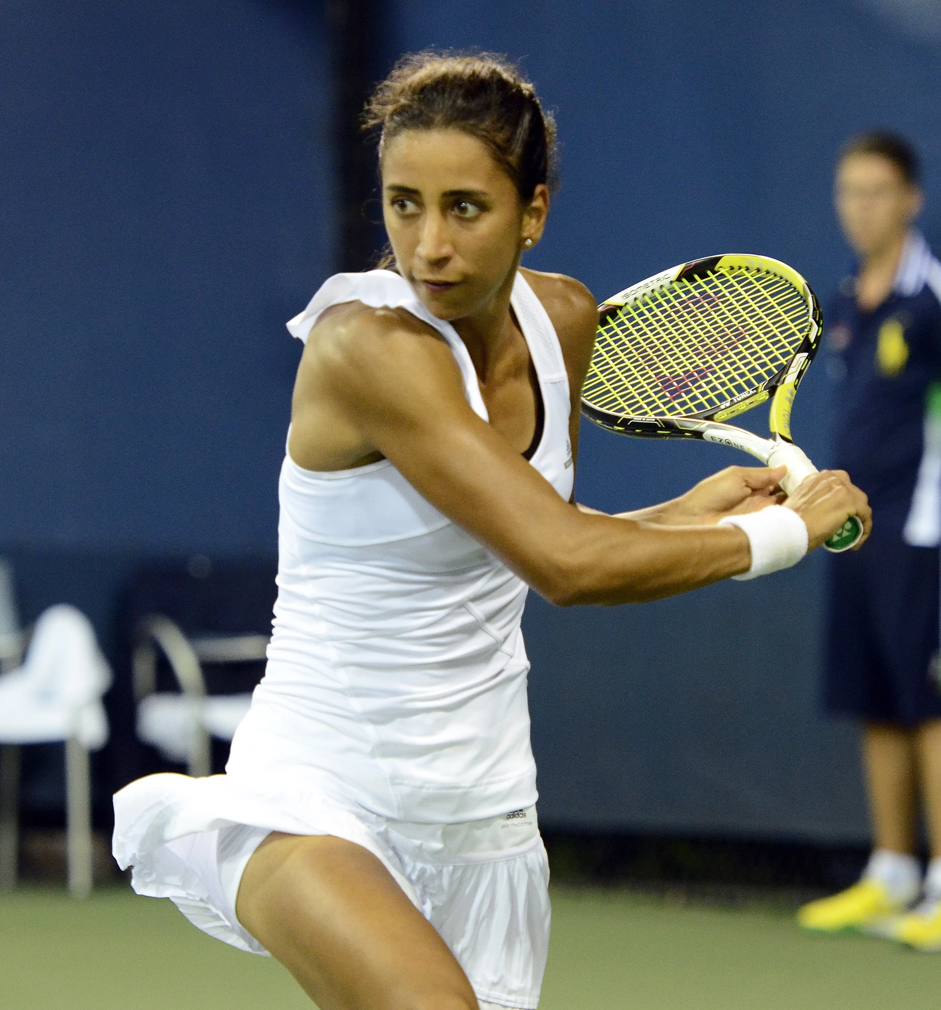 a female tennis player in the middle of action on the court