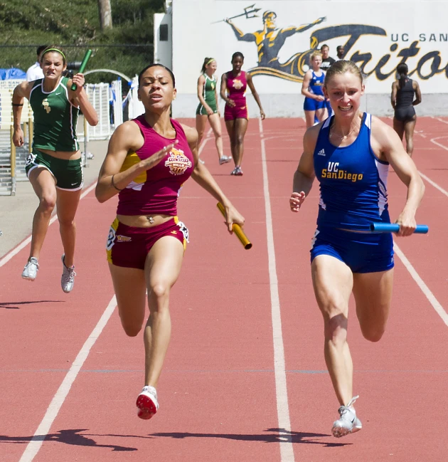 several girls racing down a track together in an event