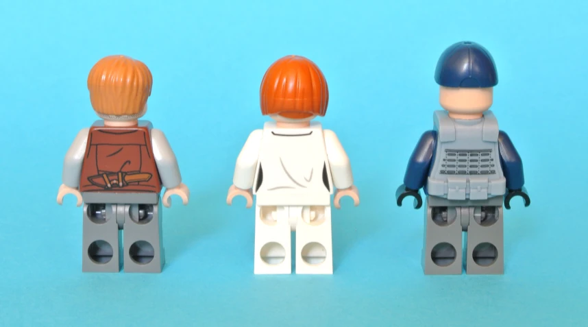 three lego figures on a blue background
