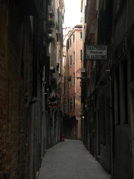 an alley way with street signs and narrow streets