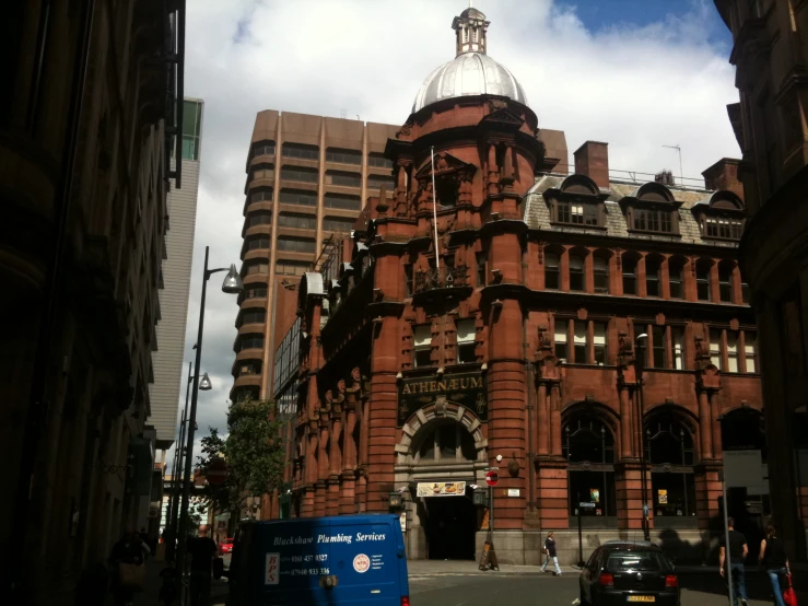 a tall building with a dome sitting next to other tall buildings