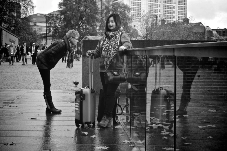 the couple is standing in front of the gate with their luggage