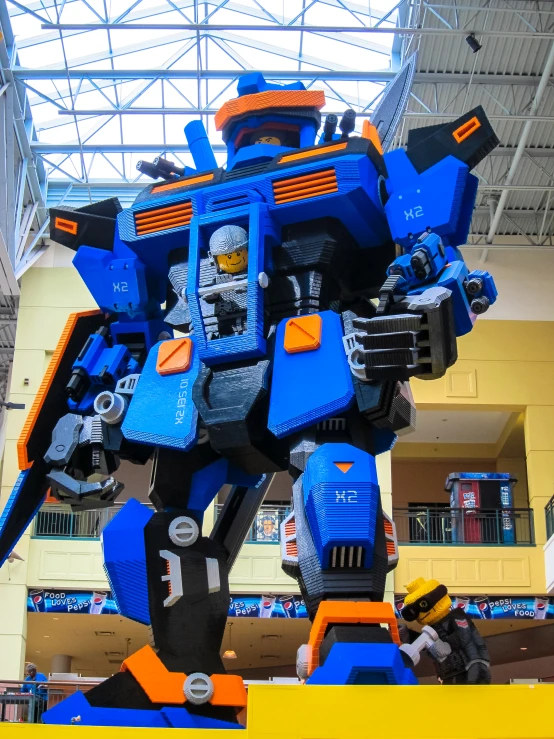 the large blue robot is on display in the building