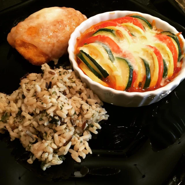 a plate of food including rice and meat