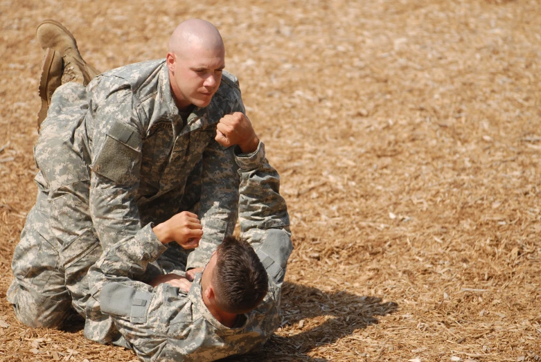 a man in fatigues is sitting down