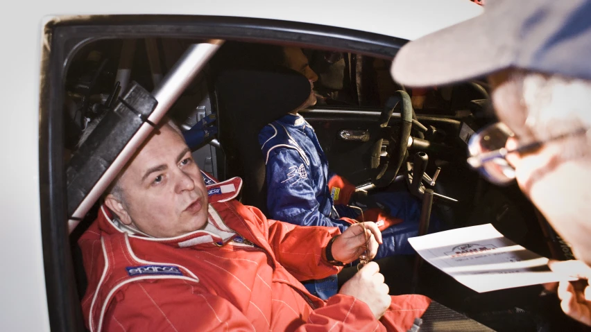 a man in a red uniform getting ready to race