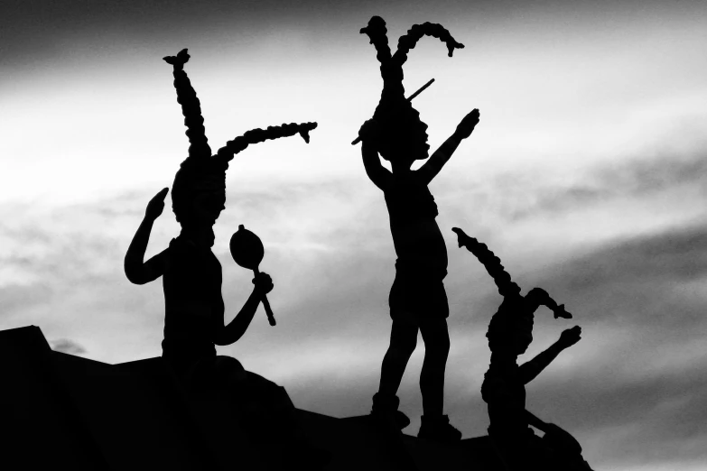 silhouette of three men standing next to each other