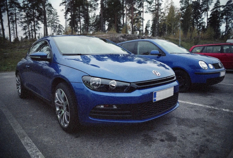 two cars parked in a parking lot near each other