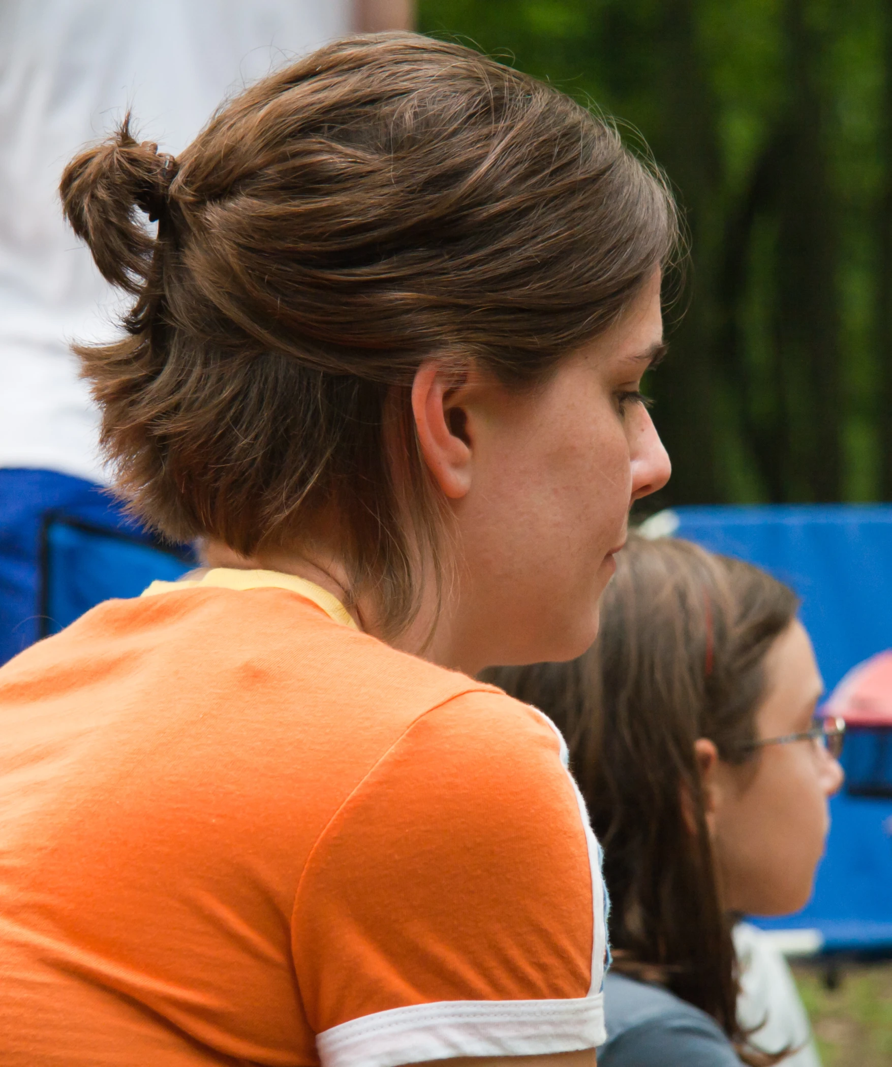 woman sitting in a row of people talking to each other