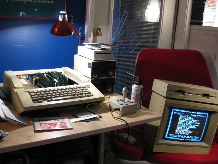 a home office desk with an old computer and desktop monitor on it