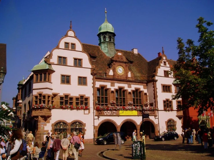 a large white and brown building with a clock