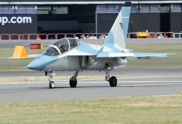 the fighter jet is sitting on the runway