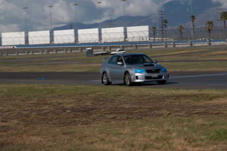 a car is on a race track in front of another car