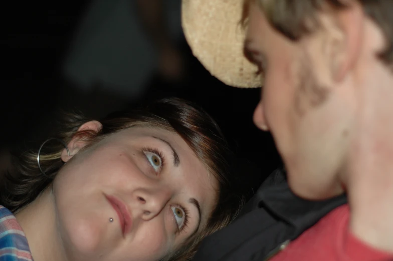 two people staring at each other in a dark room