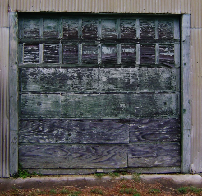 an open wooden door sitting next to a brown building