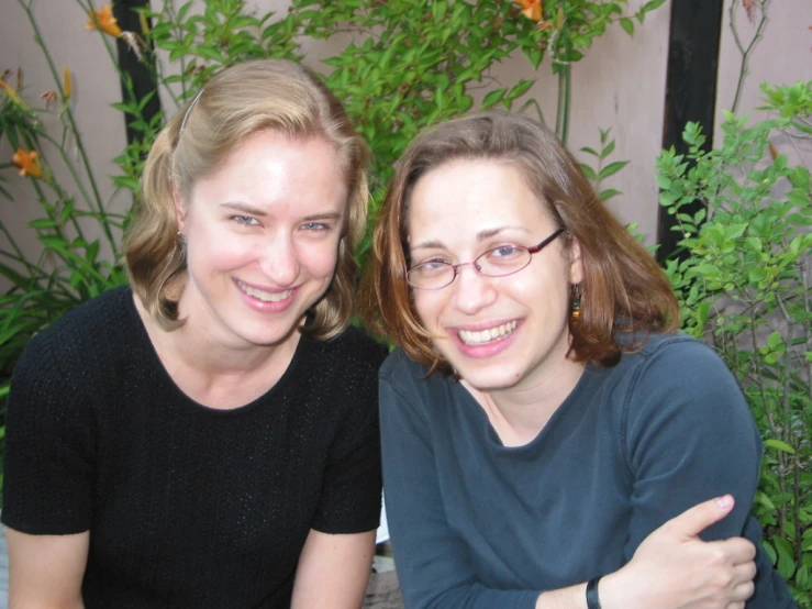 a woman is posing for the camera with her friend