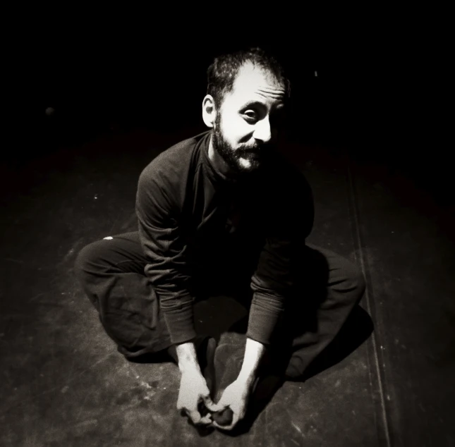 a man crouching with his hand in his hands