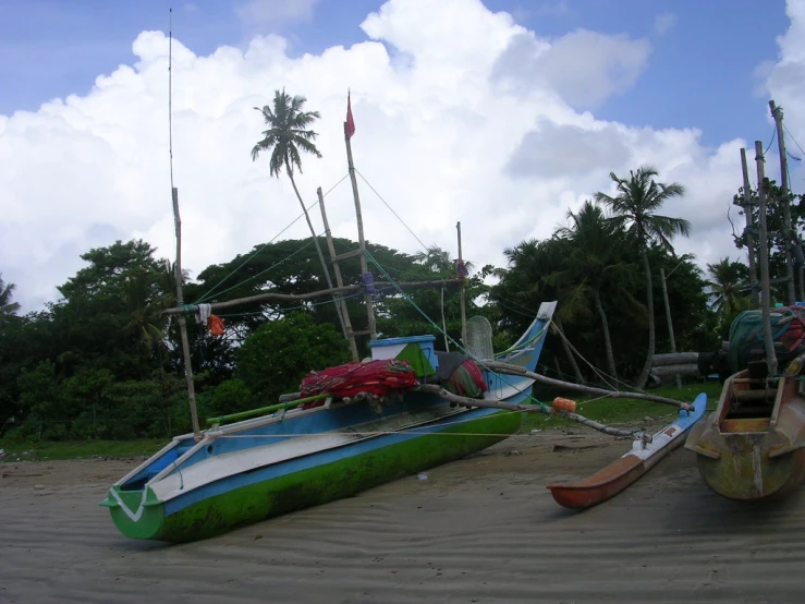 two boats that are on a sandy beach