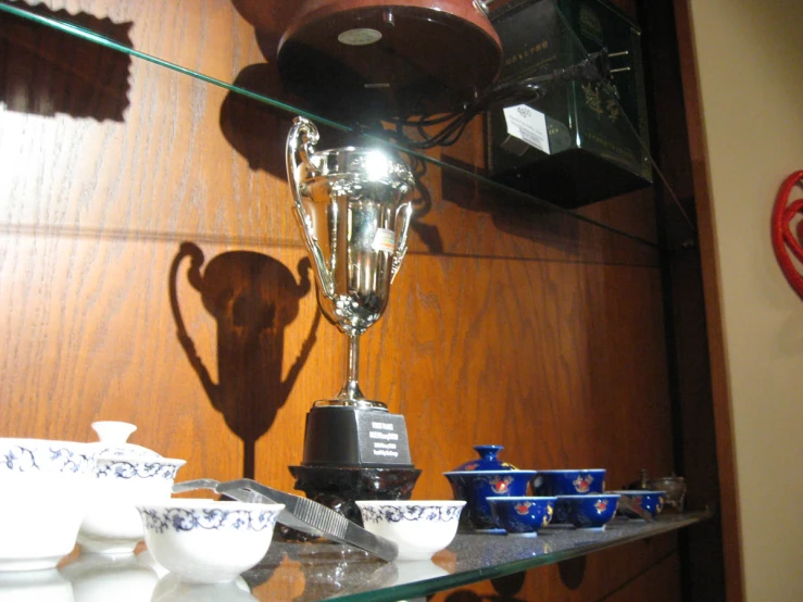 a coffeemaker on display on a glass table