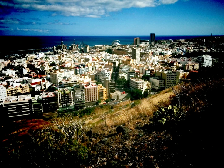 there are lots of buildings in the view from a hill