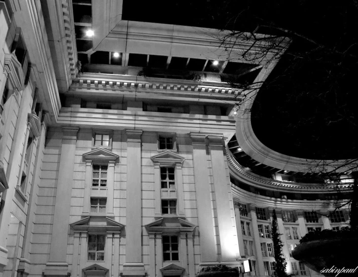 an old building with windows and some lights at night