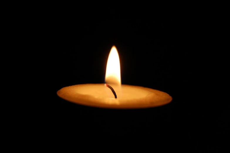 a candle lit up in the dark