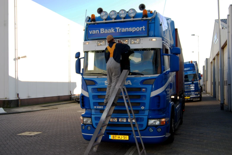 this is a man in a blue truck on the street