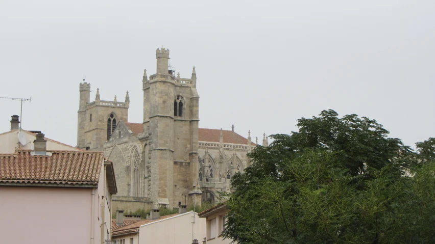 a group of buildings in the distance, with trees and sky