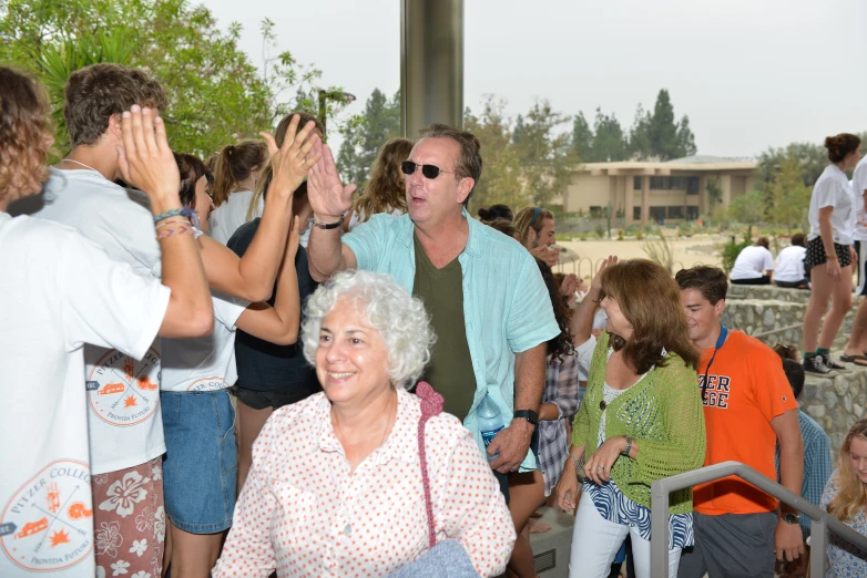 a man standing between a crowd of people in glasses