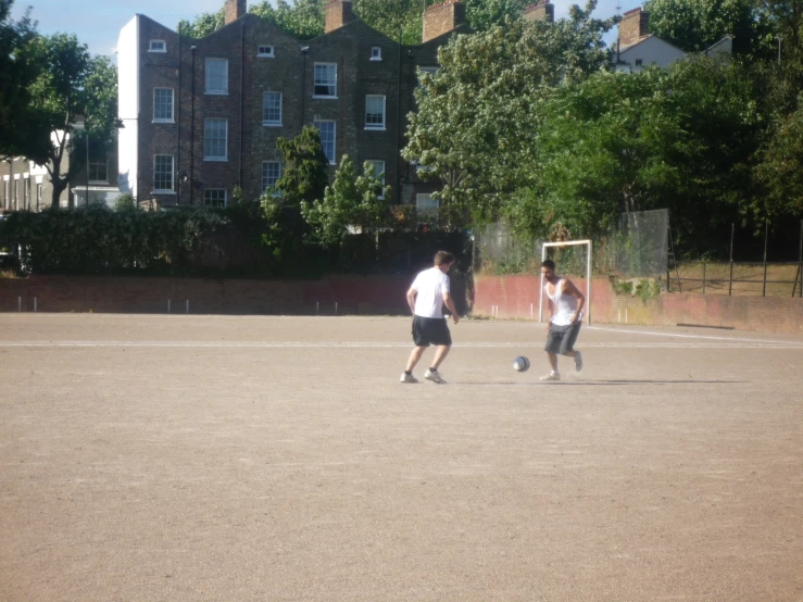 the men are playing a game of soccer outside