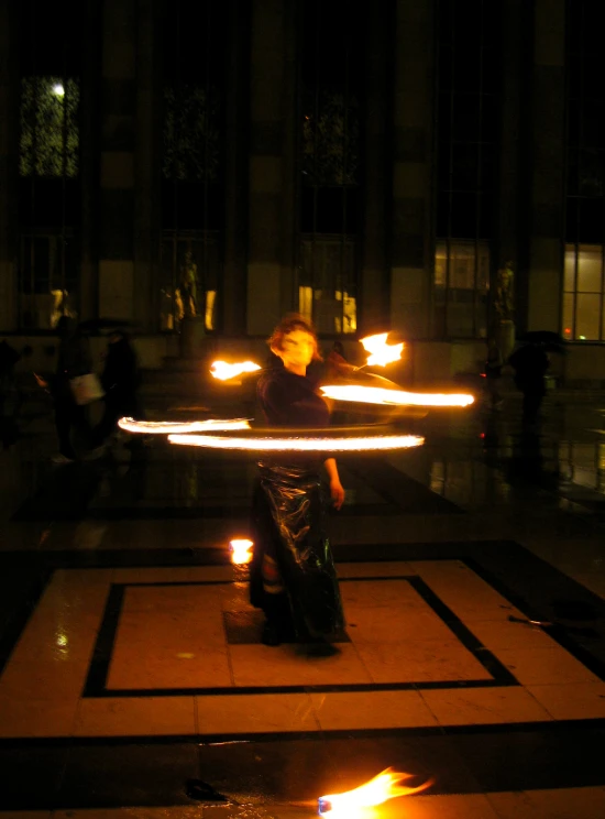 a woman sitting in the middle of some flames