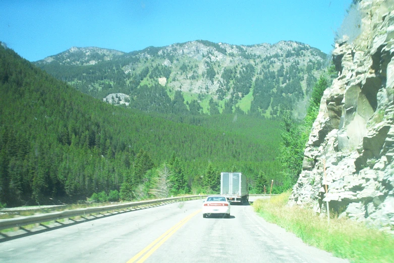 an image of a mountain scene taken from the car