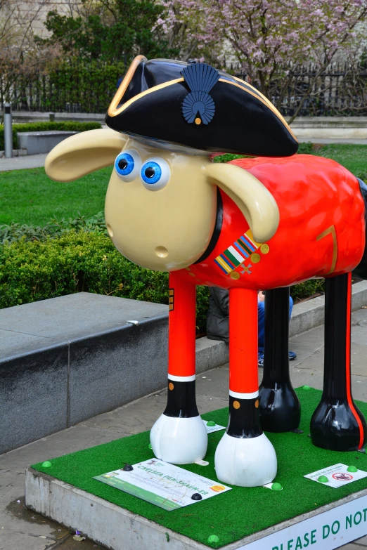 a large sculpture of a big sheep wearing a police hat