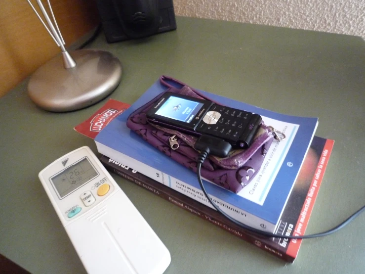 an open book sitting on top of a table next to a telephone