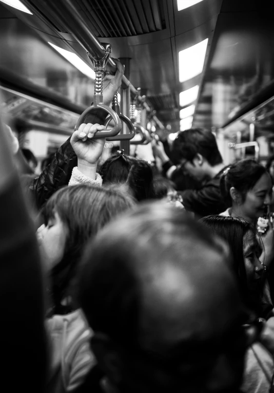 people standing in a crowded subway train car