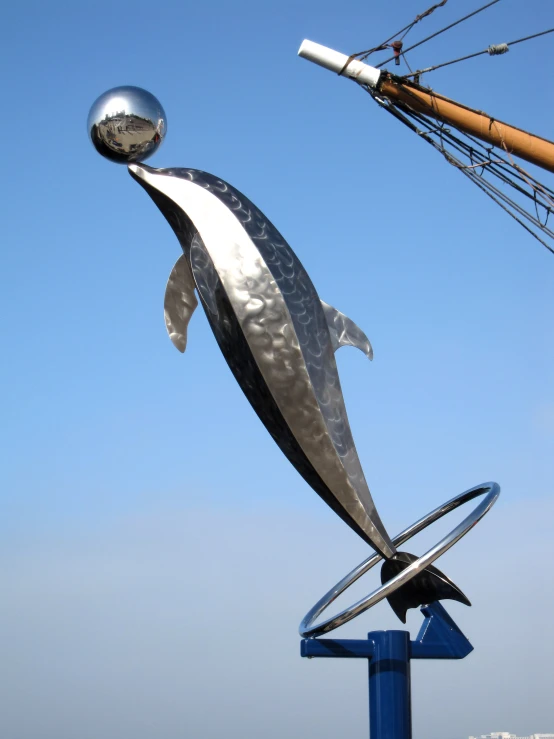 a statue is in the shape of a dolphin