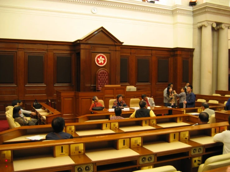 a group of people sitting in rows of desks