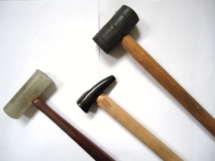four wooden mallets and some type of axe with an overclose on top