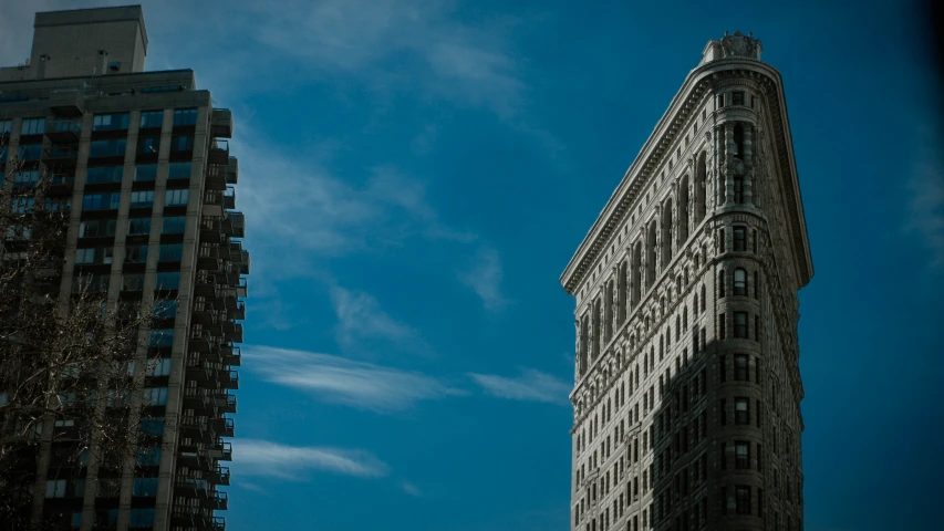 looking up at the top of two large buildings