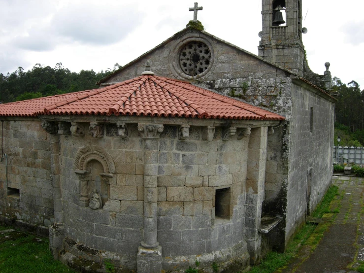 an old building with a red roof and a clock on the wall